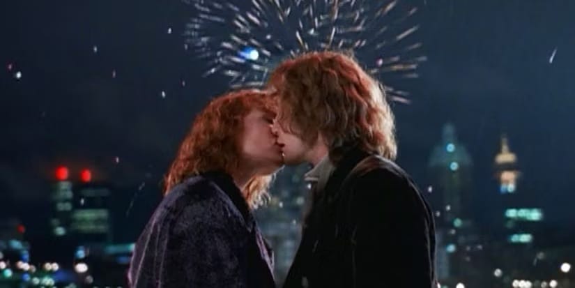 Dr. Grace Holloway (Daphe Ashbrook) and the Eighth Doctor (Paul McGann) kiss as fireworks go off behind them.
